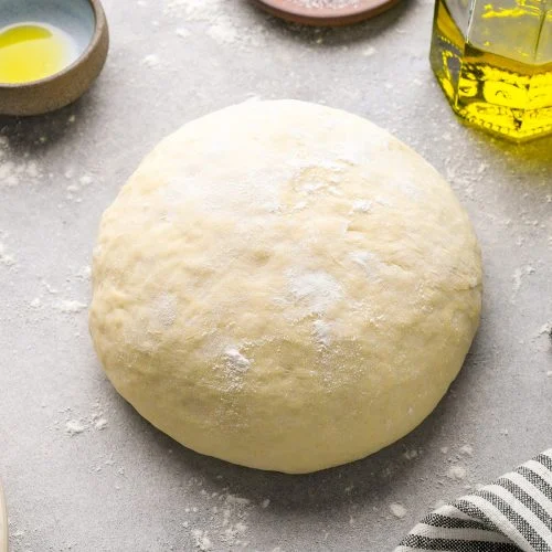 Dough being stretched by hand